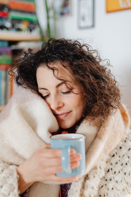 person relaxing with eyes closed in a comfortable setting